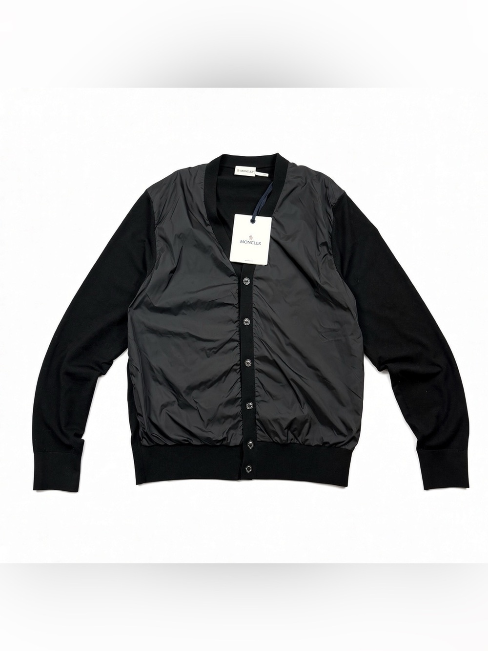 Moncler Maglia Tricot cardigan.
Black knit sleeves and body with nylon front pa